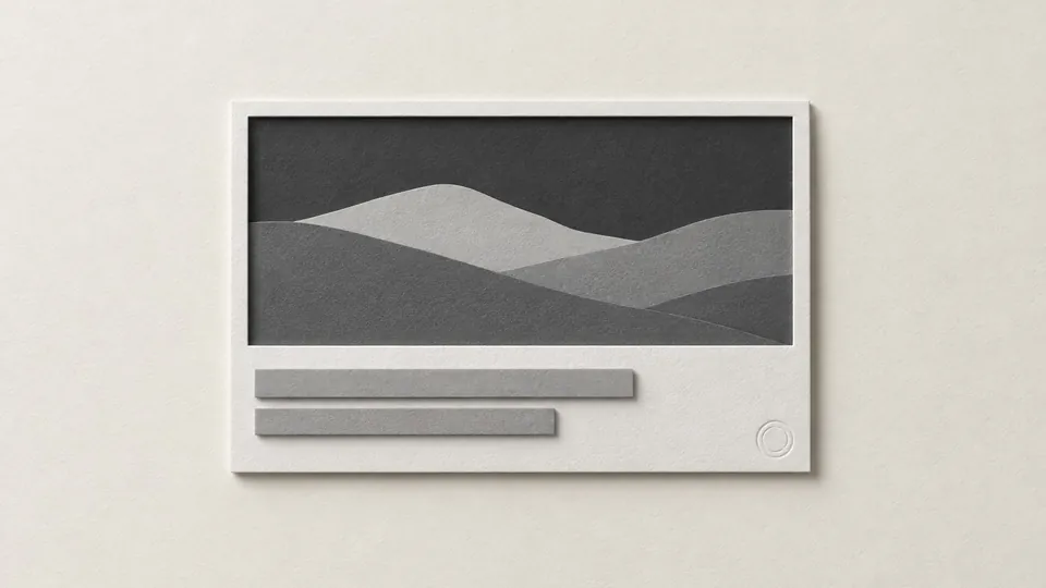 A cut-paper link preview card with a grey landscape panel, two blank text bars and a small embossed seal in one corner