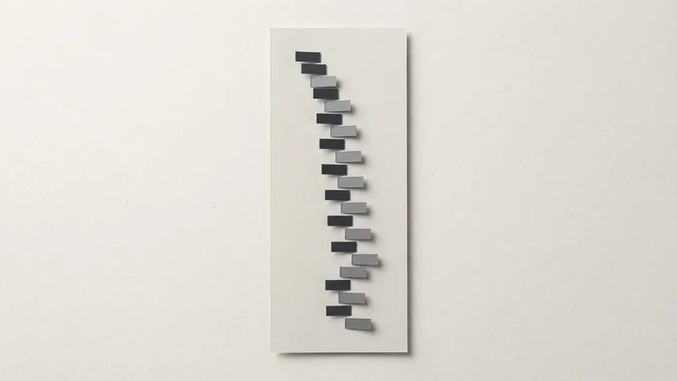 A tall pale paper ledger sheet with small graphite and grey paper tabs stepping down it in rows, like an index of entries